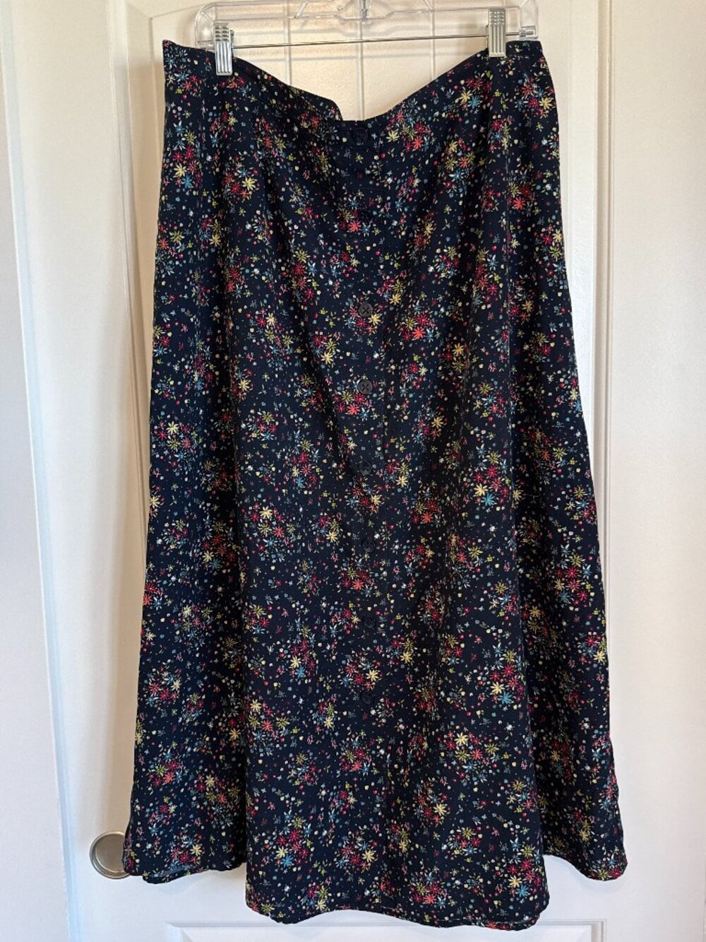Vintage-inspired black midi skirt with colorful ditsy floral print